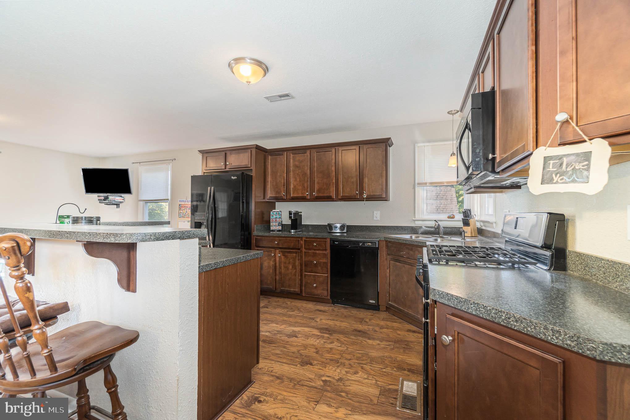 404 Beaumont Road York, PA 17403 - Photo 4 of 26 a kitchen with kitchen island granite countertop a sink cabinets and stainless steel appliances