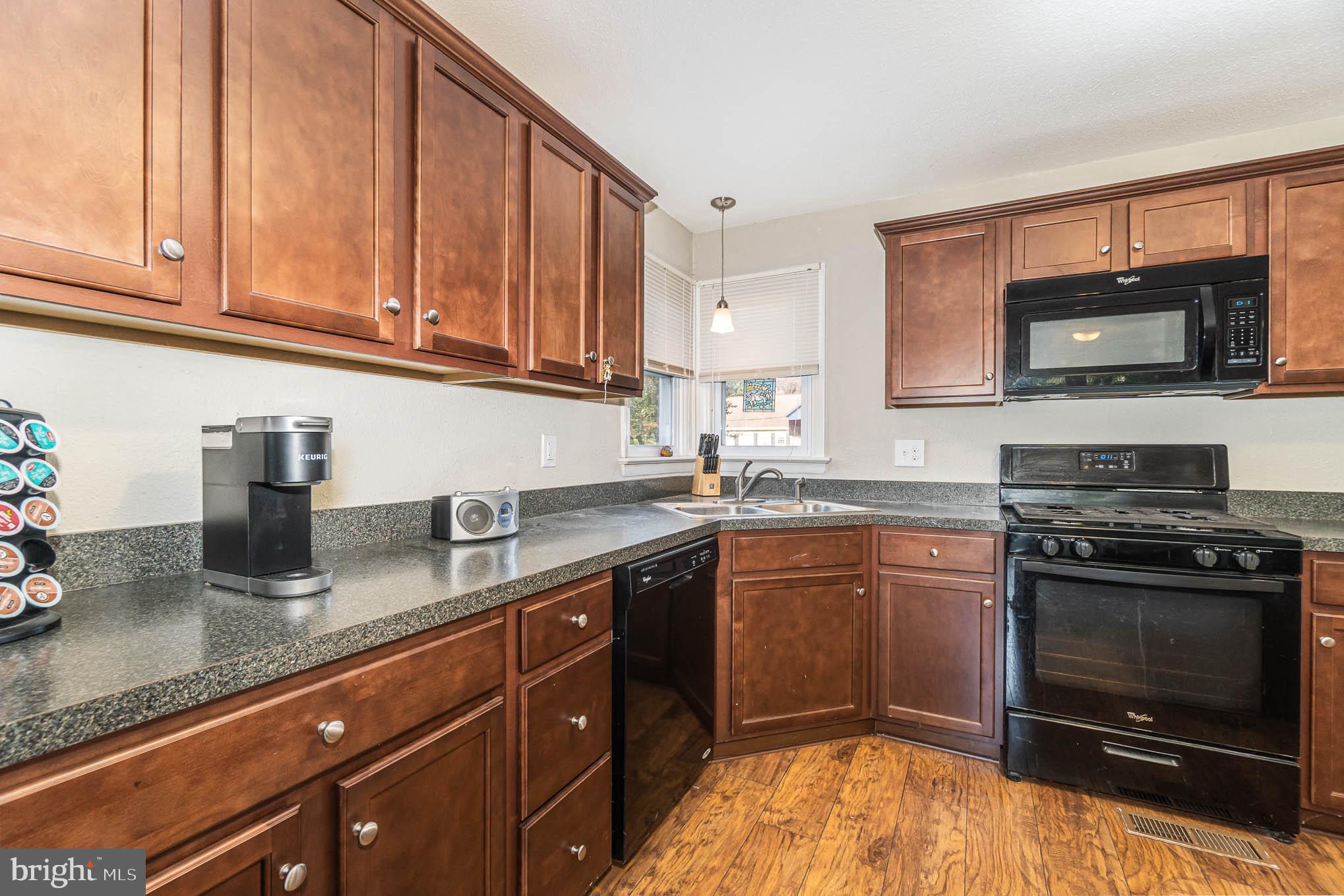 404 Beaumont Road York, PA 17403 - Photo 5 of 26 a kitchen with granite countertop a sink stove and microwave