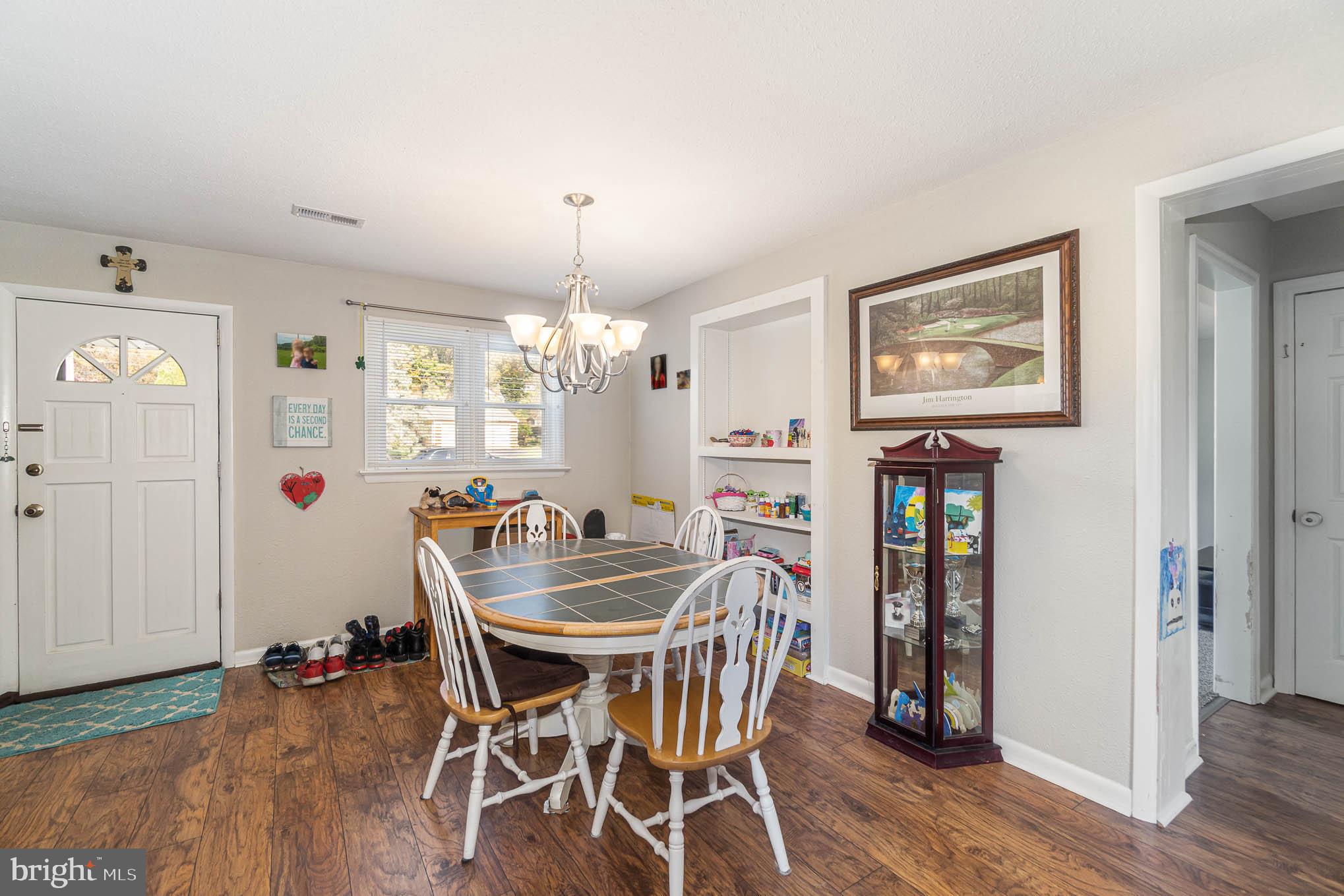 404 Beaumont Road York, PA 17403 - Photo 8 of 26 a dining room with furniture wooden floor a rug and a chandelier