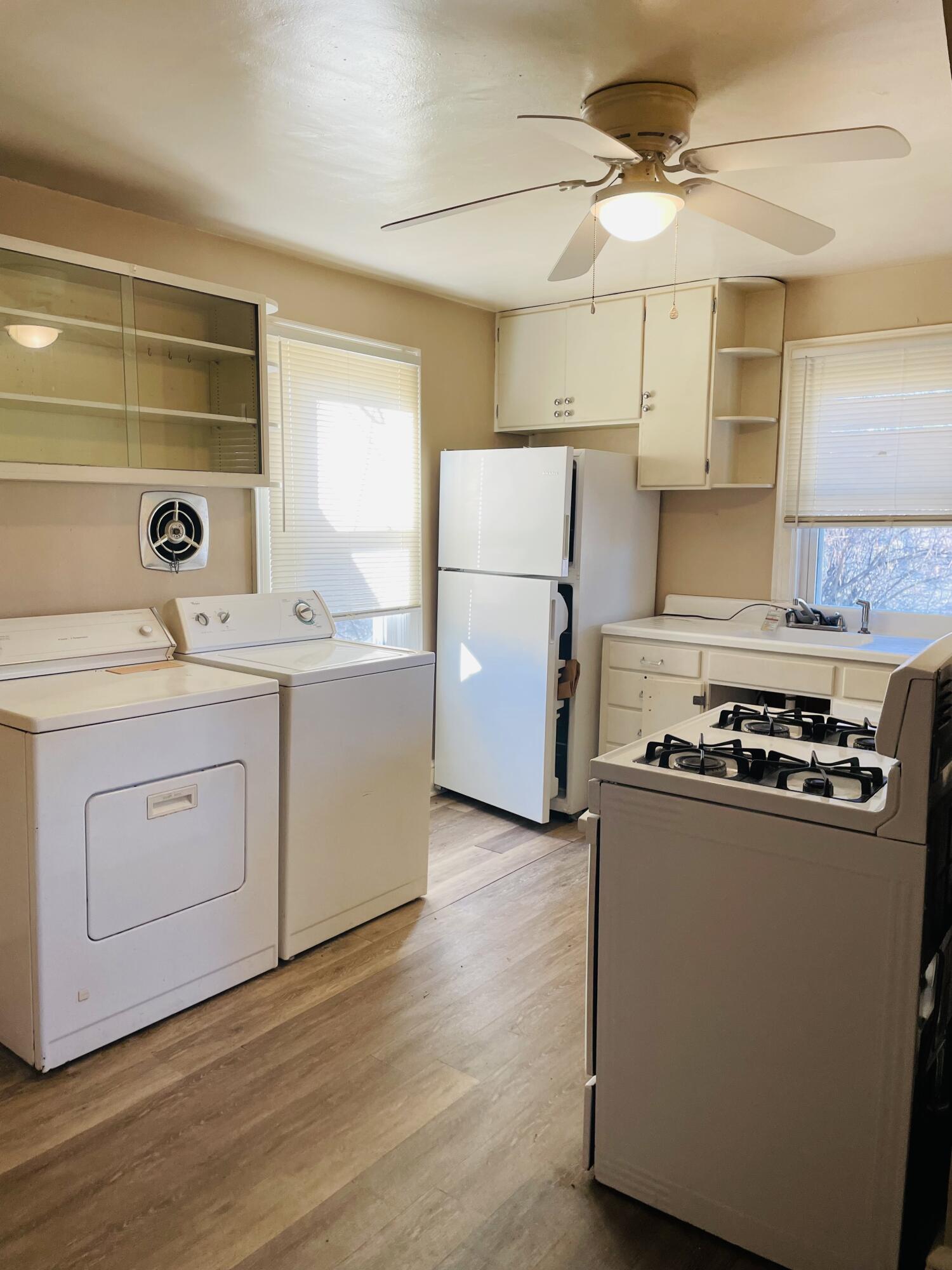 1152 Hamilton Avenue Southwest Roanoke, VA 24015 - Photo 18 of 36 a kitchen with a stove a refrigerator and a cabinets