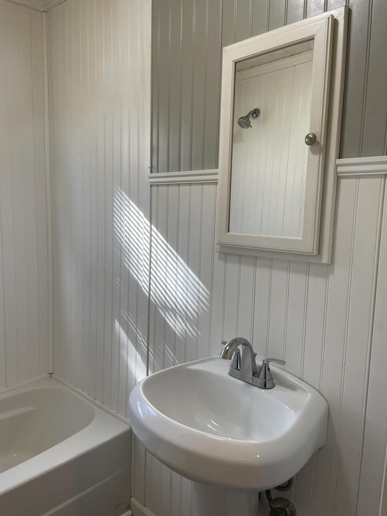 1152 Hamilton Avenue Southwest Roanoke, VA 24015 - Photo 21 of 36 a bathroom with a sink and a mirror