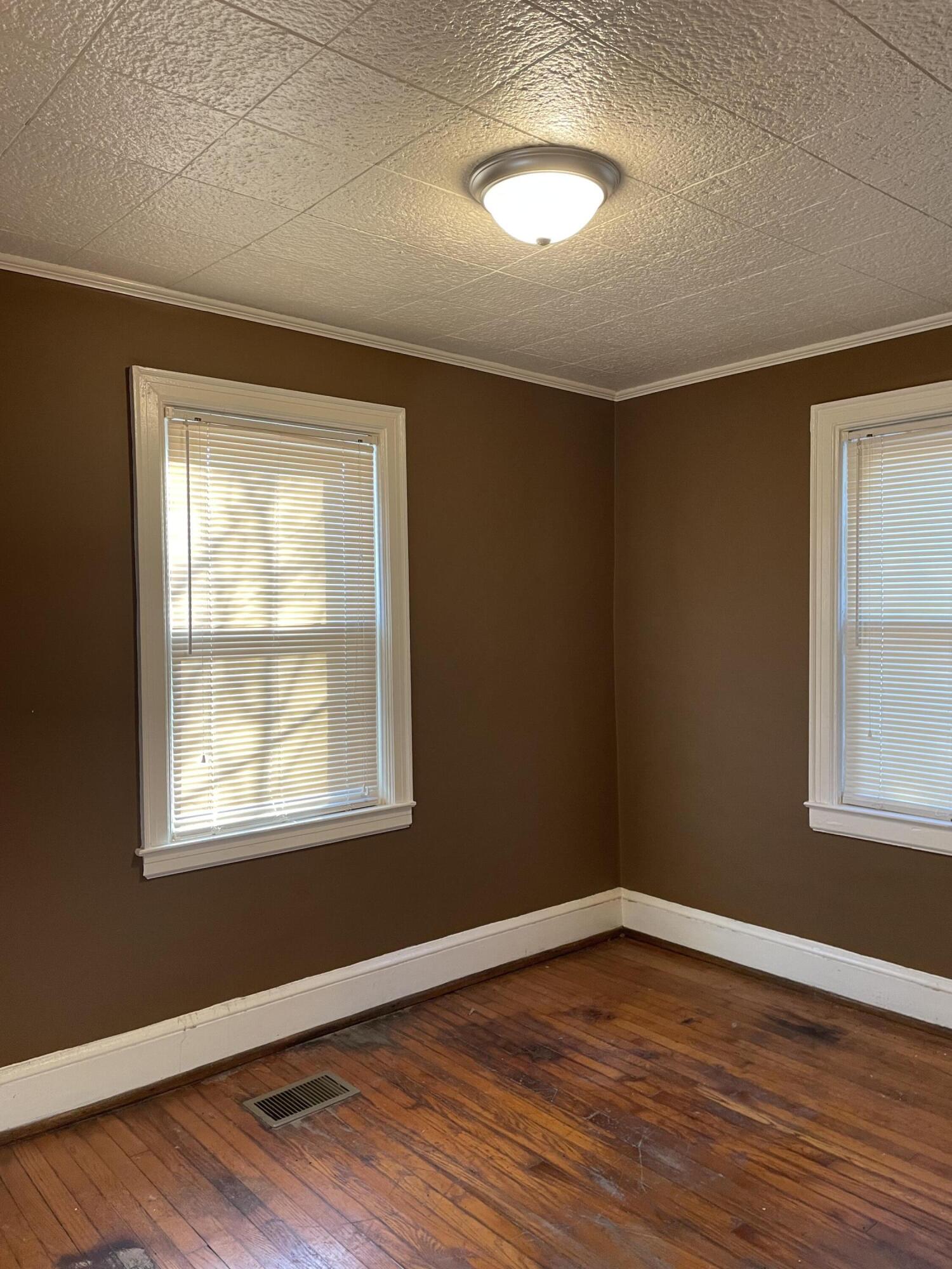 1152 Hamilton Avenue Southwest Roanoke, VA 24015 - Photo 26 of 36 a view of an empty room with wooden floor and a window