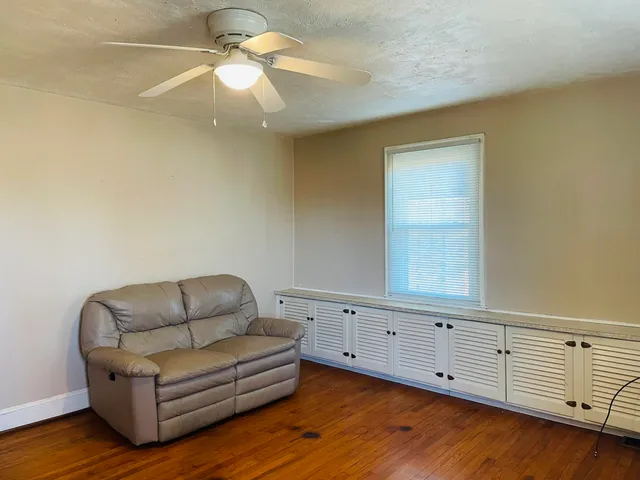 a view of staircase with white walls and a window