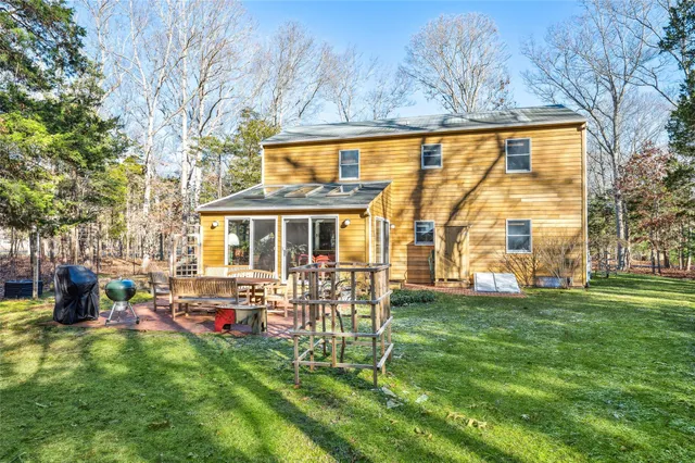 a living room with furniture a chandelier and a floor to ceiling window