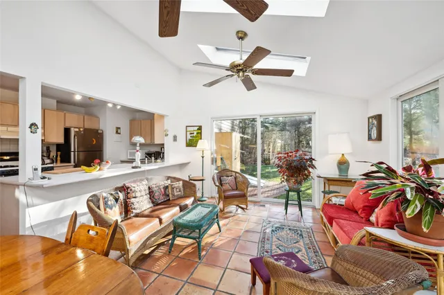 a kitchen with stainless steel appliances kitchen island granite countertop a sink and cabinets