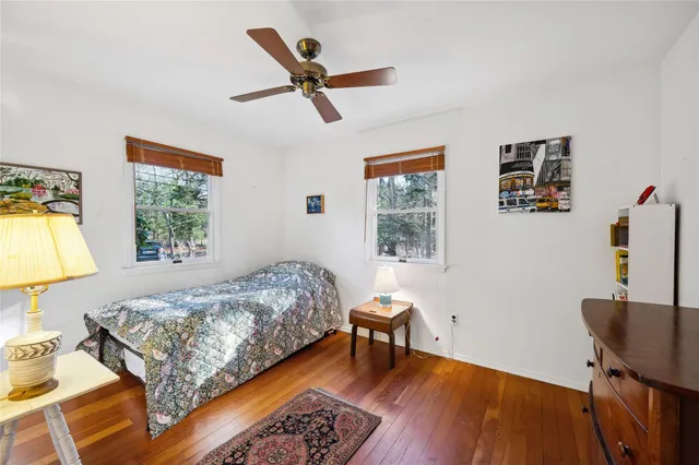 a bathroom with a granite countertop toilet and a sink