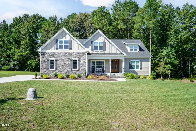a front view of house with yard and green space