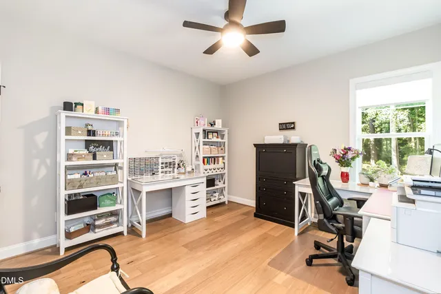 a view of a hallway and a room with wooden floor