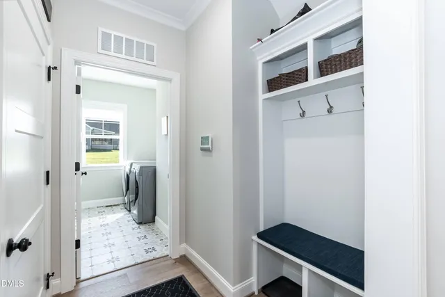 a view of a hallway and a room with wooden floor