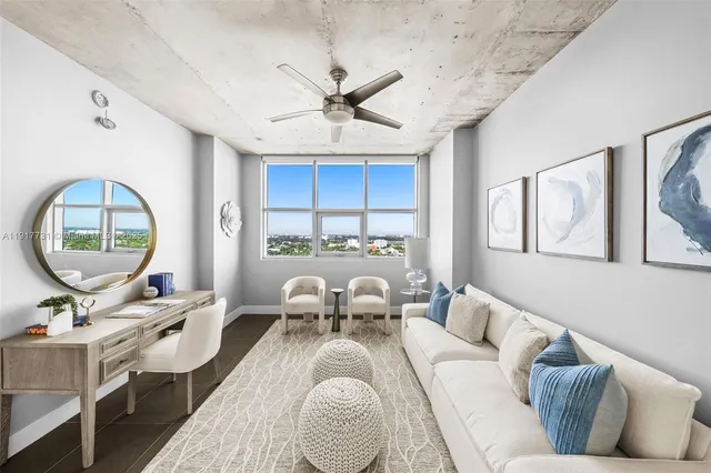 a living room with furniture a mirror and a table