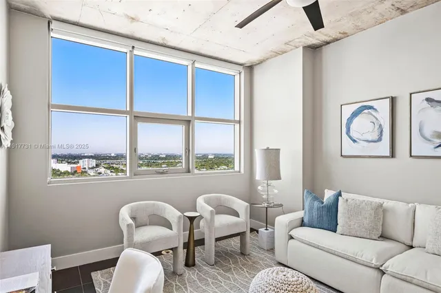 a living room with furniture and a large window