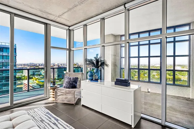 a dining room with glass windows and furniture
