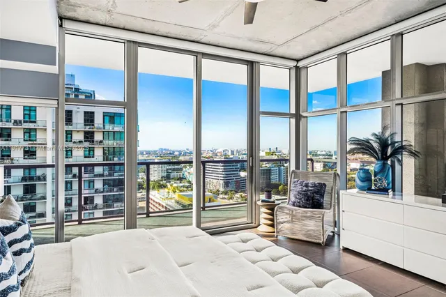 a bedroom with furniture and large window