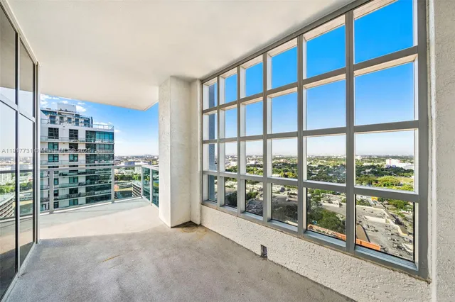 a view of an empty room with windows