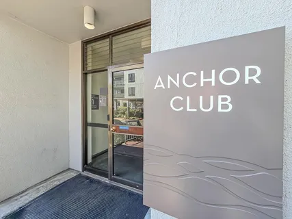 a view of a terrace with lawn chairs
