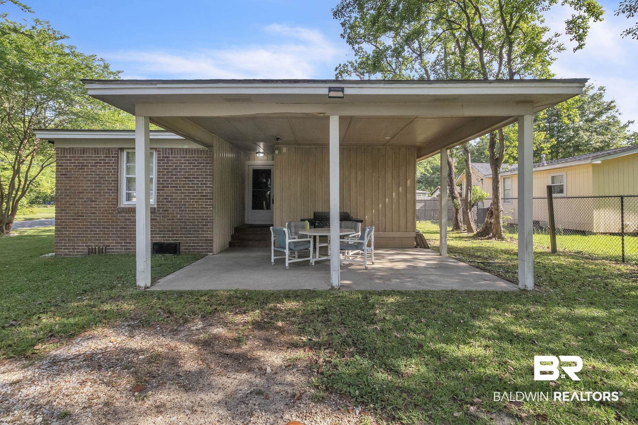 315 Fourth Avenue Chickasaw, AL 36611 - Photo 13 of 28 View of patio / terrace with fence and entry steps