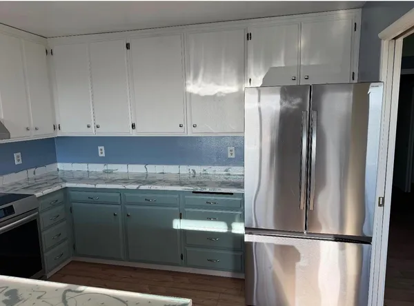 a kitchen with granite countertop a sink a stove and cabinets