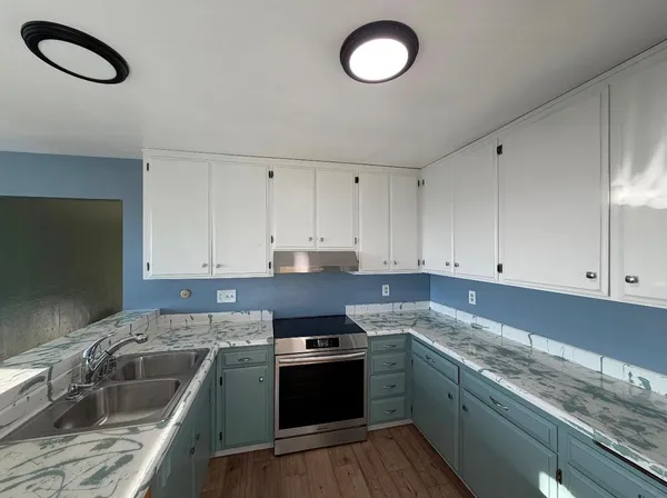 a view of empty room with window and wooden floor