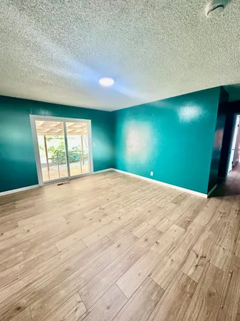 a view of an empty room and a fireplace