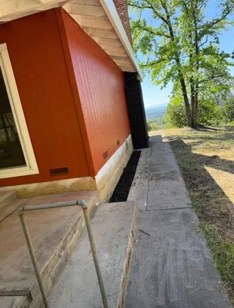 a view of a backyard with swimming pool