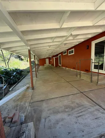 a view of a storage and utility room with wooden floor
