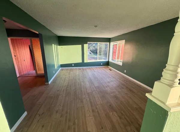 a kitchen with granite countertop a sink a stove and cabinets