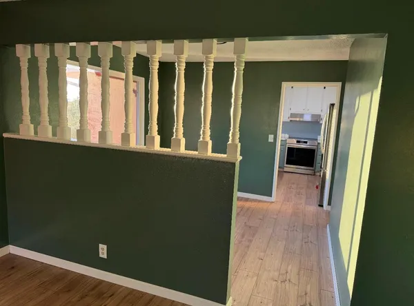 a kitchen with granite countertop a refrigerator and a sink