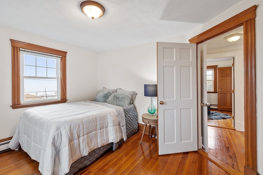 3 Baker Road Nahant, MA 01908 - Photo 21 of 41 a bedroom with a bed and wooden floor