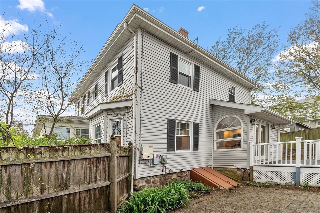 3 Baker Road Nahant, MA 01908 - Photo 35 of 41 a view of a house with a small yard and wooden fence