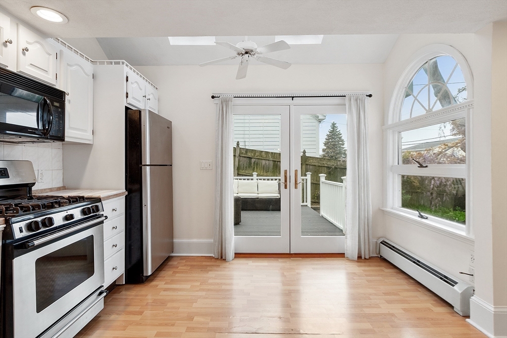 3 Baker Road Nahant, MA 01908 - Photo 7 of 41 a view of a kitchen with a stove cabinets and a fireplace