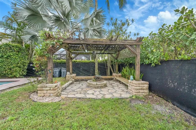 a view of a chair and table in backyard of the house