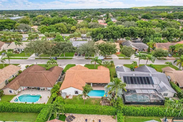 an aerial view of a house with garden space and lake view