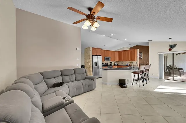 a living room with furniture and kitchen view