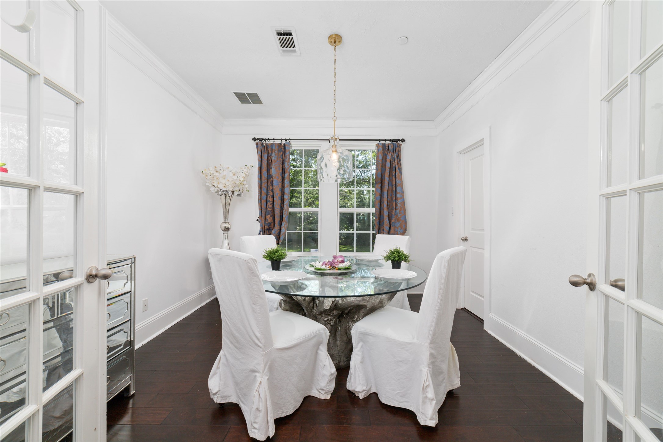 335 Voss Road Houston, TX 77024 - Photo 31 of 45 a dining room with furniture a chandelier and wooden floor