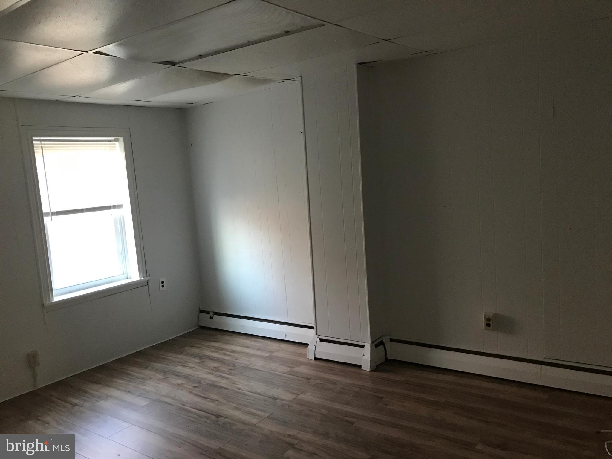 27 Upland Avenue Brookhaven, PA 19015 - Photo 8 of 8 an empty room with wooden floor and windows