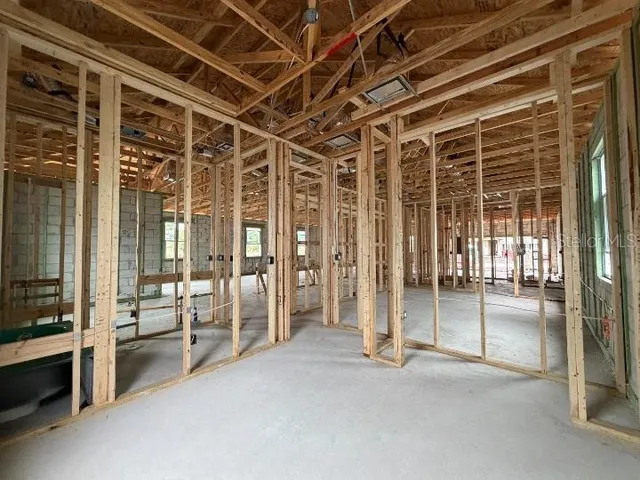 a view of an entryway with wooden floor and a livingroom