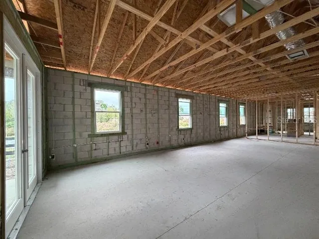 a view of a hallway with closet and a window