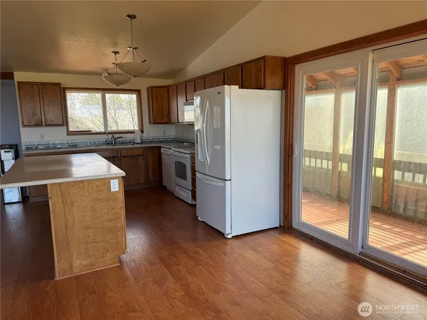 a kitchen with refrigerator a sink and cabinets
