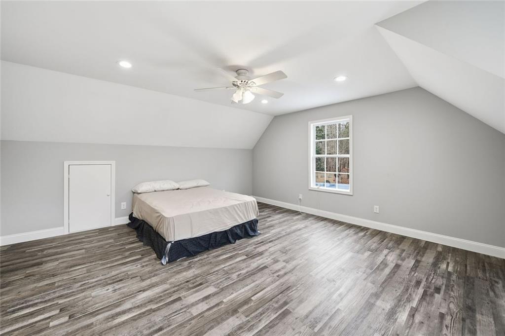 1006 Owens Store Road Canton, GA 30115 - Photo 31 of 48 a view of a livingroom with a ceiling fan and wooden floor