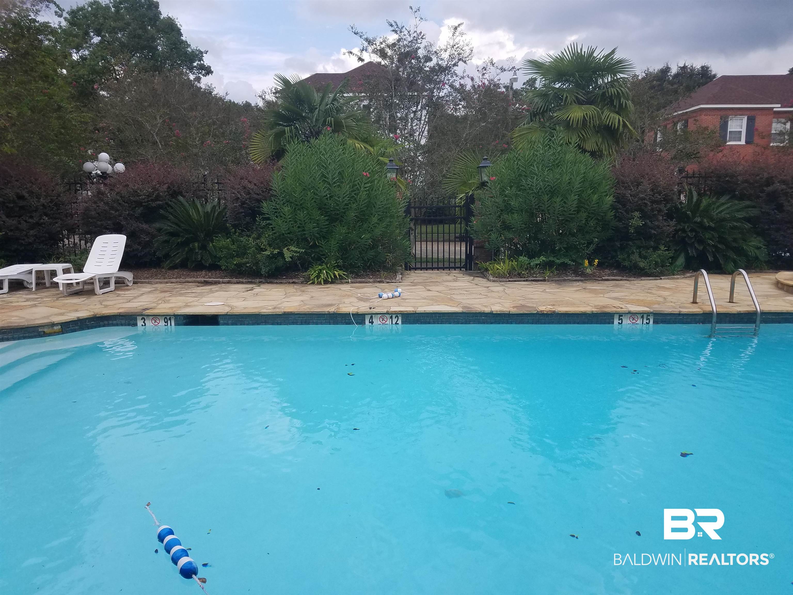 214 Upham Street, Unit 7C Mobile, AL 36607 - Photo 28 of 32 Community pool with a patio area and a gate
