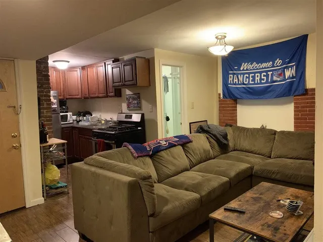 a living room with furniture and a lamp
