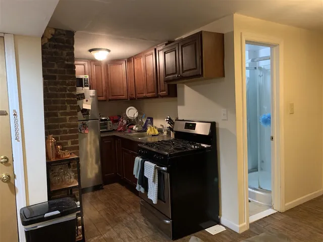 a kitchen with stainless steel appliances granite countertop a stove and a refrigerator