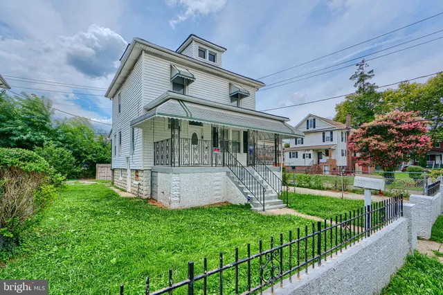 a front view of a house with a garden and plants