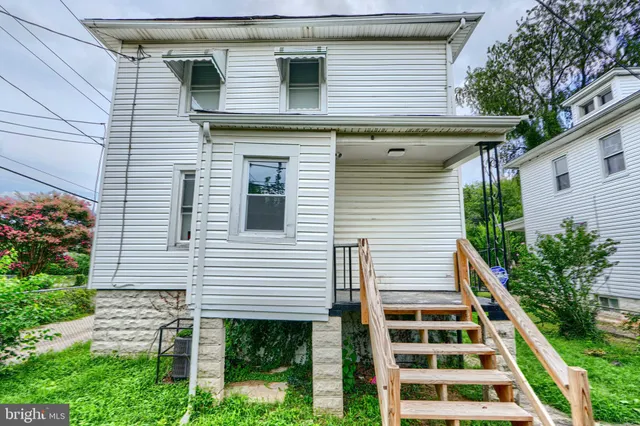 a front view of a house with plants