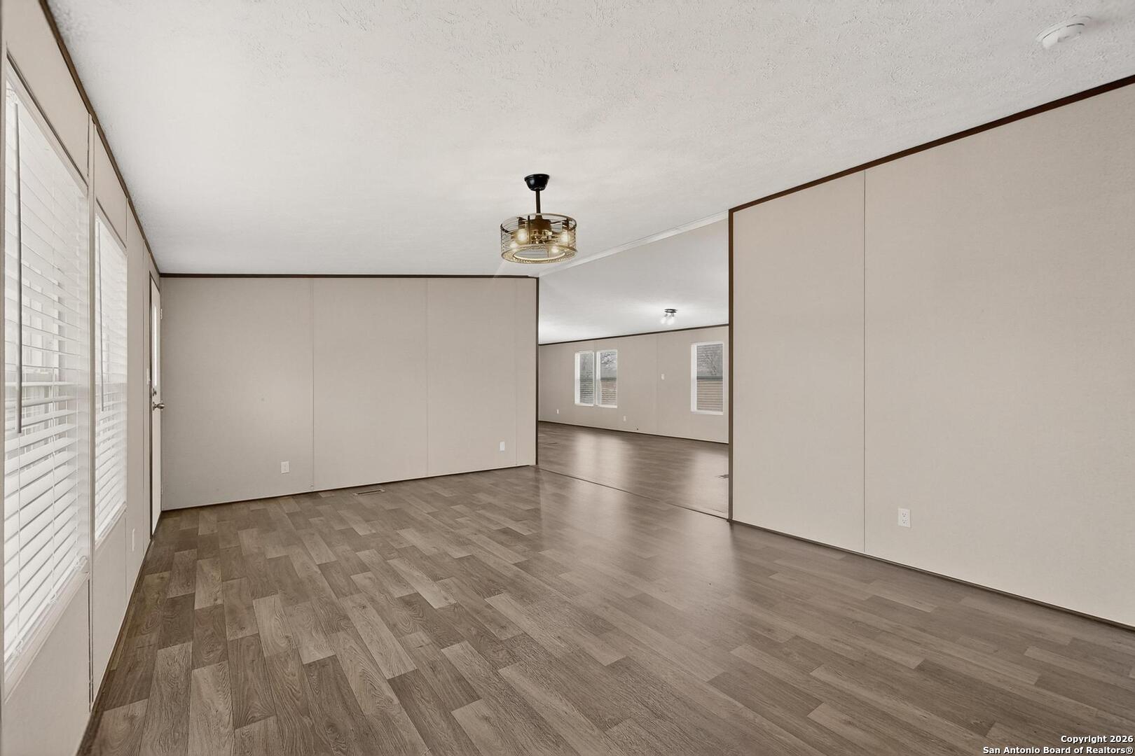 19124 La Gloria Road Elmendorf, TX 78112 - Photo 11 of 45 a view of a livingroom with wooden floor
