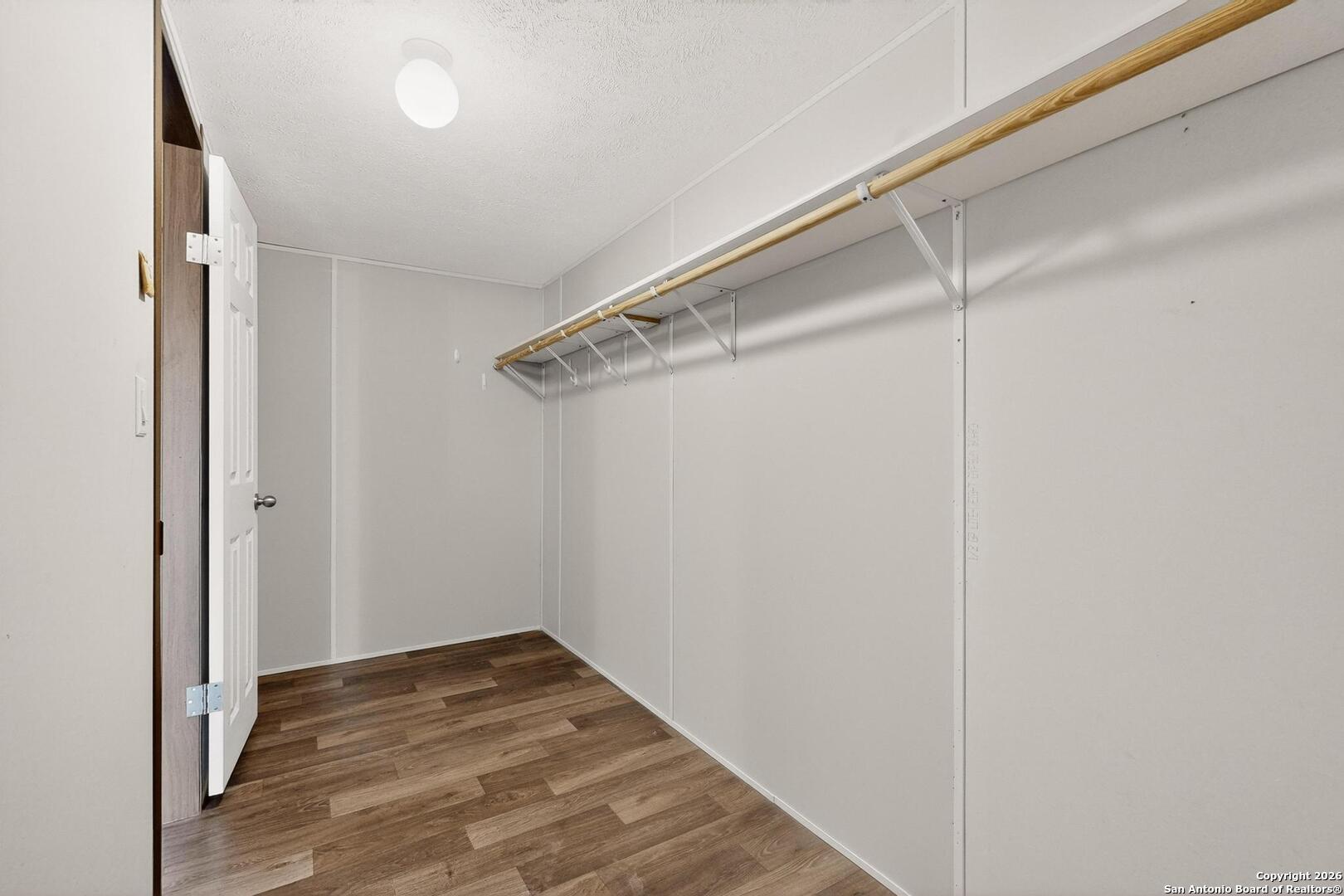 19124 La Gloria Road Elmendorf, TX 78112 - Photo 22 of 45 a view of a room with wooden floor