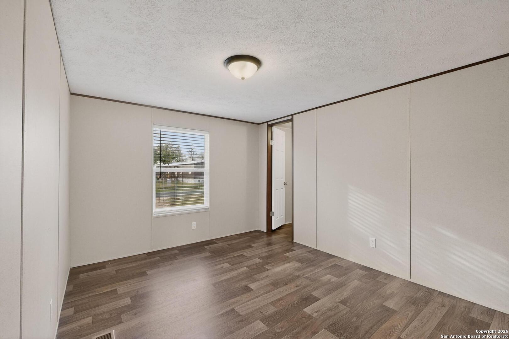 19124 La Gloria Road Elmendorf, TX 78112 - Photo 27 of 45 a view of an empty room with a window