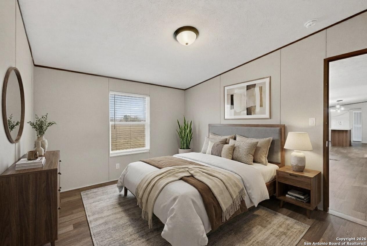 19124 La Gloria Road Elmendorf, TX 78112 - Photo 28 of 45 a bedroom with a bed and a window