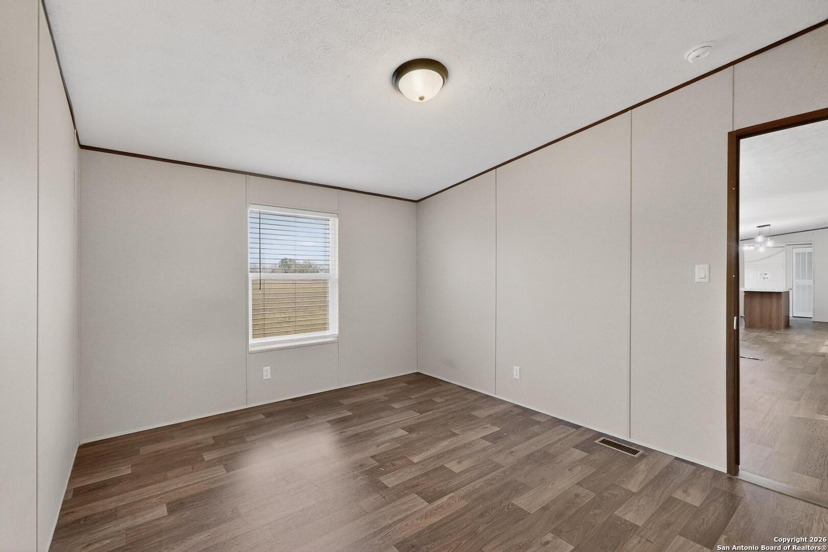 19124 La Gloria Road Elmendorf, TX 78112 - Photo 29 of 45 a view of empty room with wooden floor