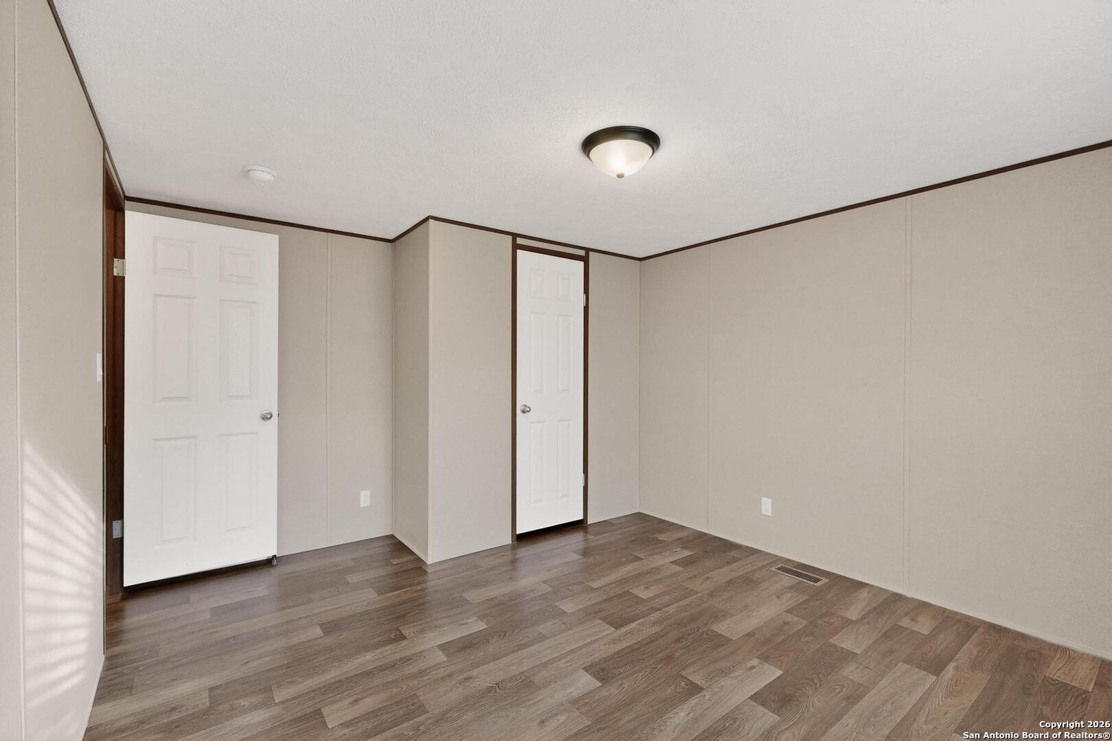 19124 La Gloria Road Elmendorf, TX 78112 - Photo 30 of 45 a view of a room with wooden floor